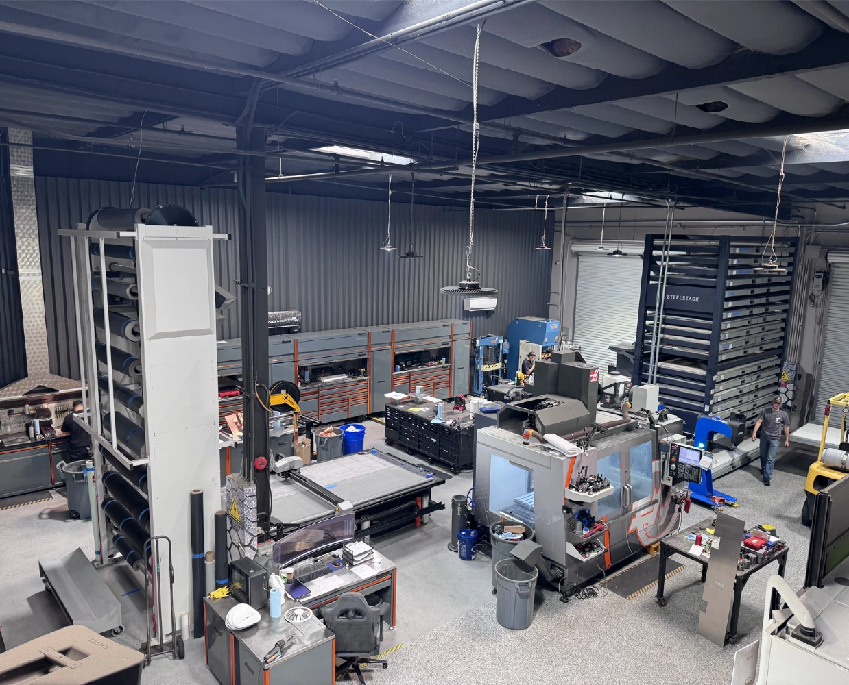 Interior of Flash-Tech Manufacturing facility with industrial machines producing single-ply roofing accessories.